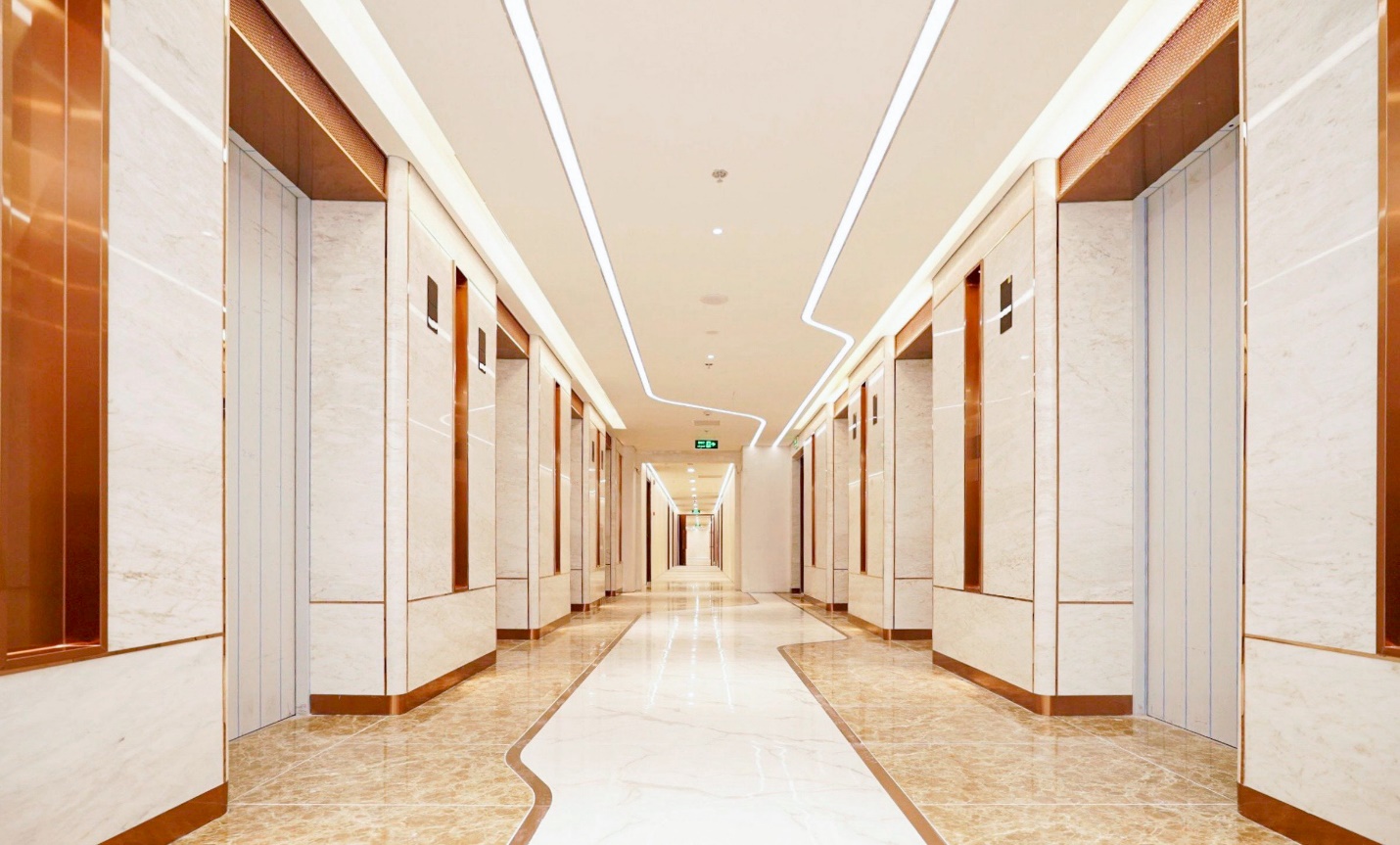 A long hallway with white walls  Description automatically generated