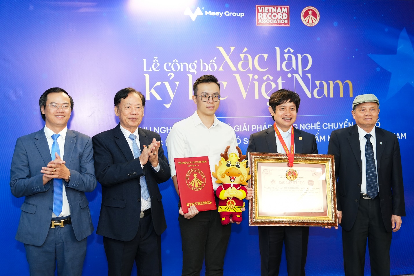 A group of men standing together holding awards  Description automatically generated