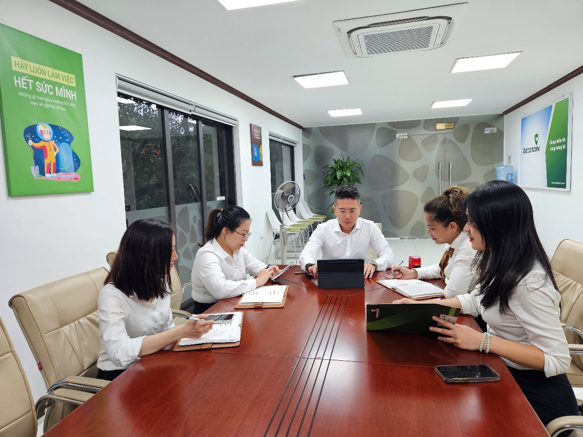 A group of people sitting around a table  Description automatically generated