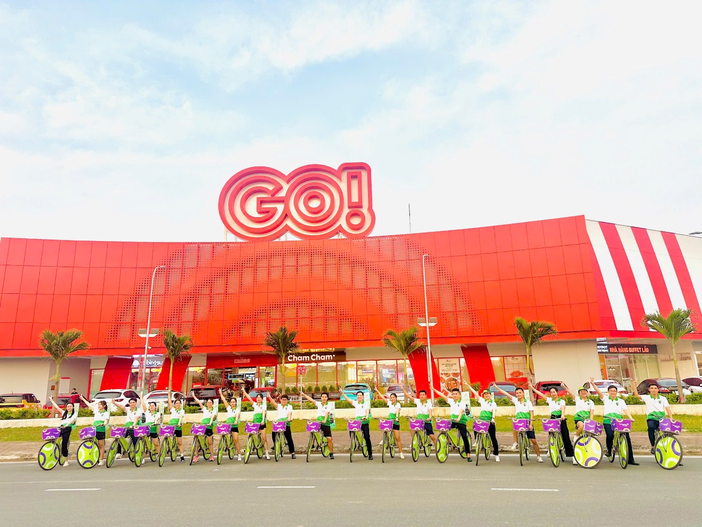 A group of people on bicycles in front of a building  Description automatically generated