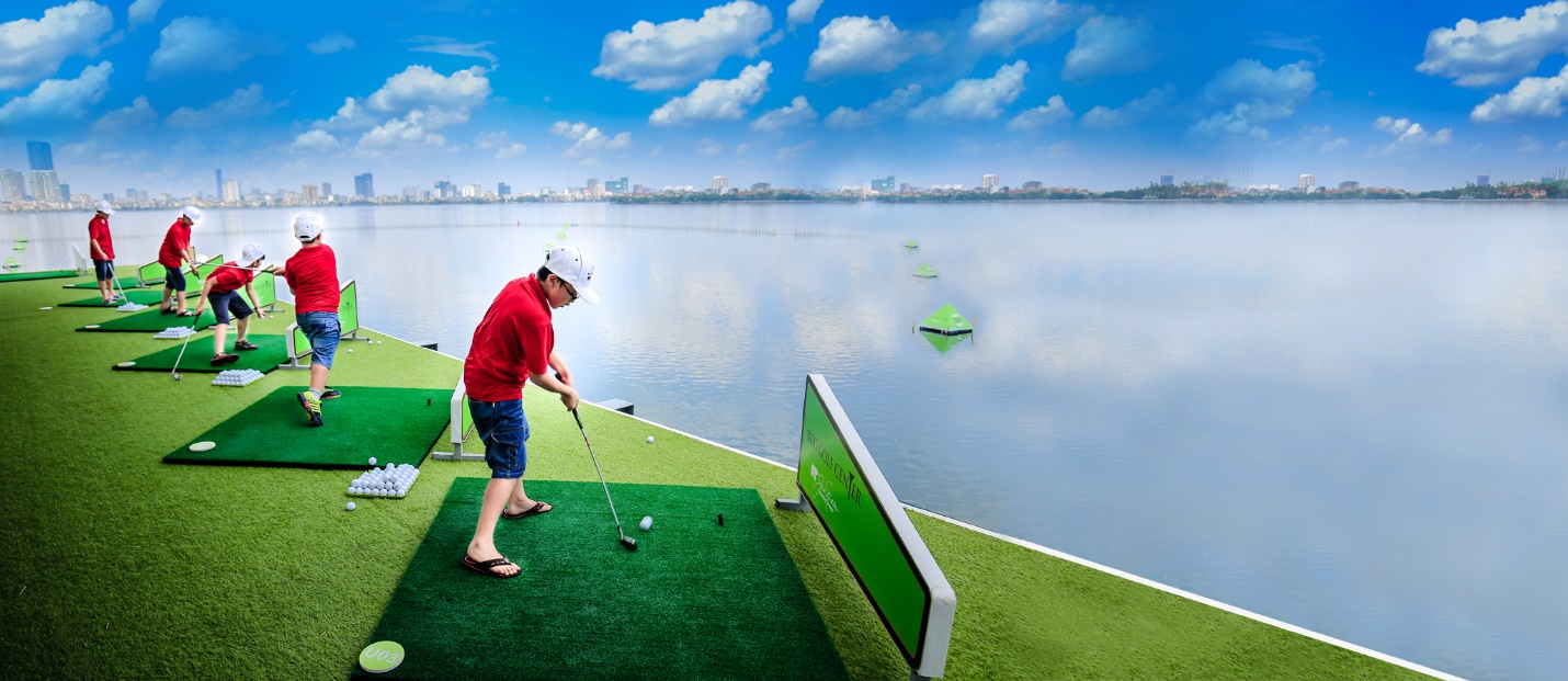 A person playing golf on a green surface  Description automatically generated