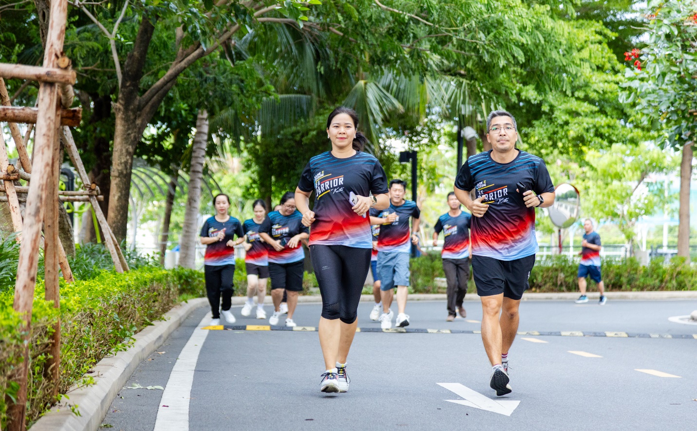 A group of people running on a street  Description automatically generated