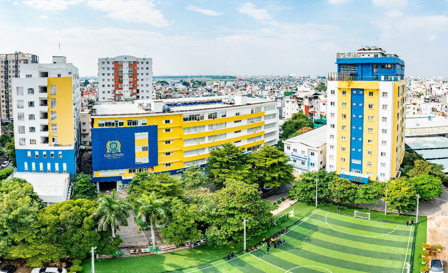 Asean Business Awards 2025 vinh danh Tập đoàn Nguyễn Hoàng trong Top 10 Thương hiệu uy tín hàng đầu khu vực- Ảnh 3. A group of buildings with trees and grass  AI-generated content may be incorrect.