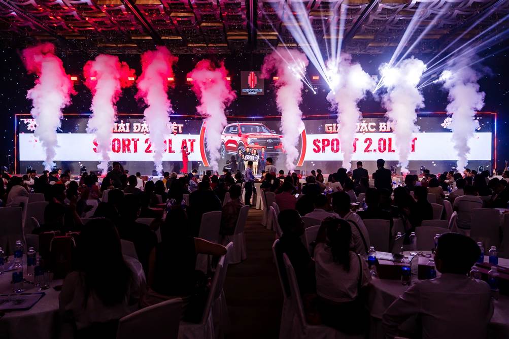 A group of people sitting in chairs and a stage with smoke  AI-generated content may be incorrect.
