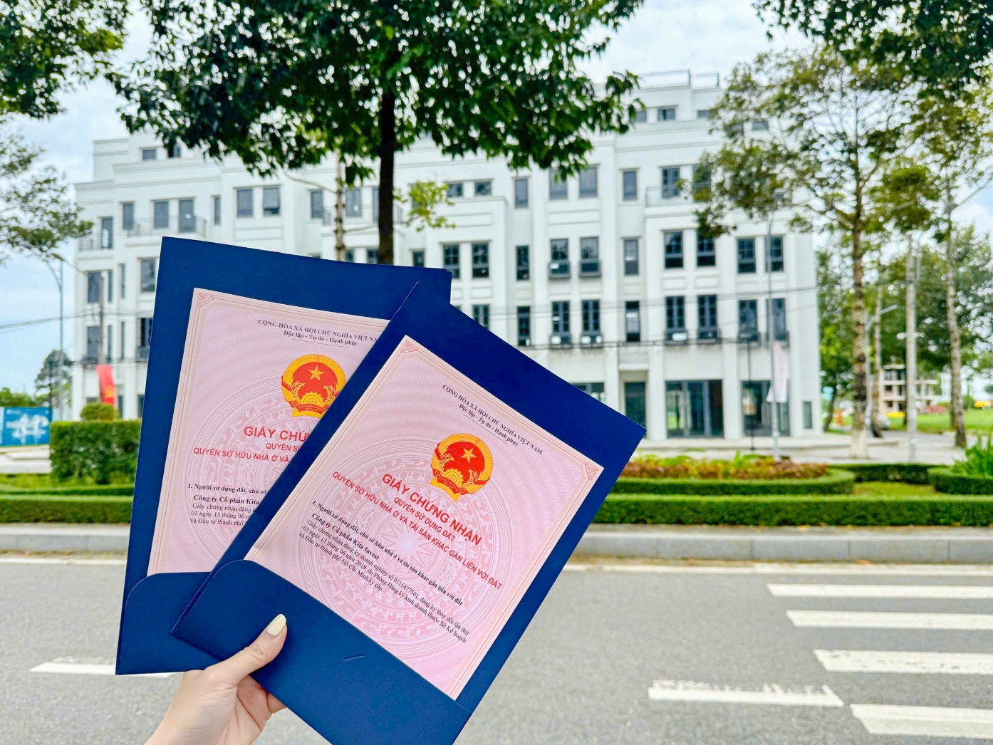 A hand holding a pair of blue papers  AI-generated content may be incorrect.