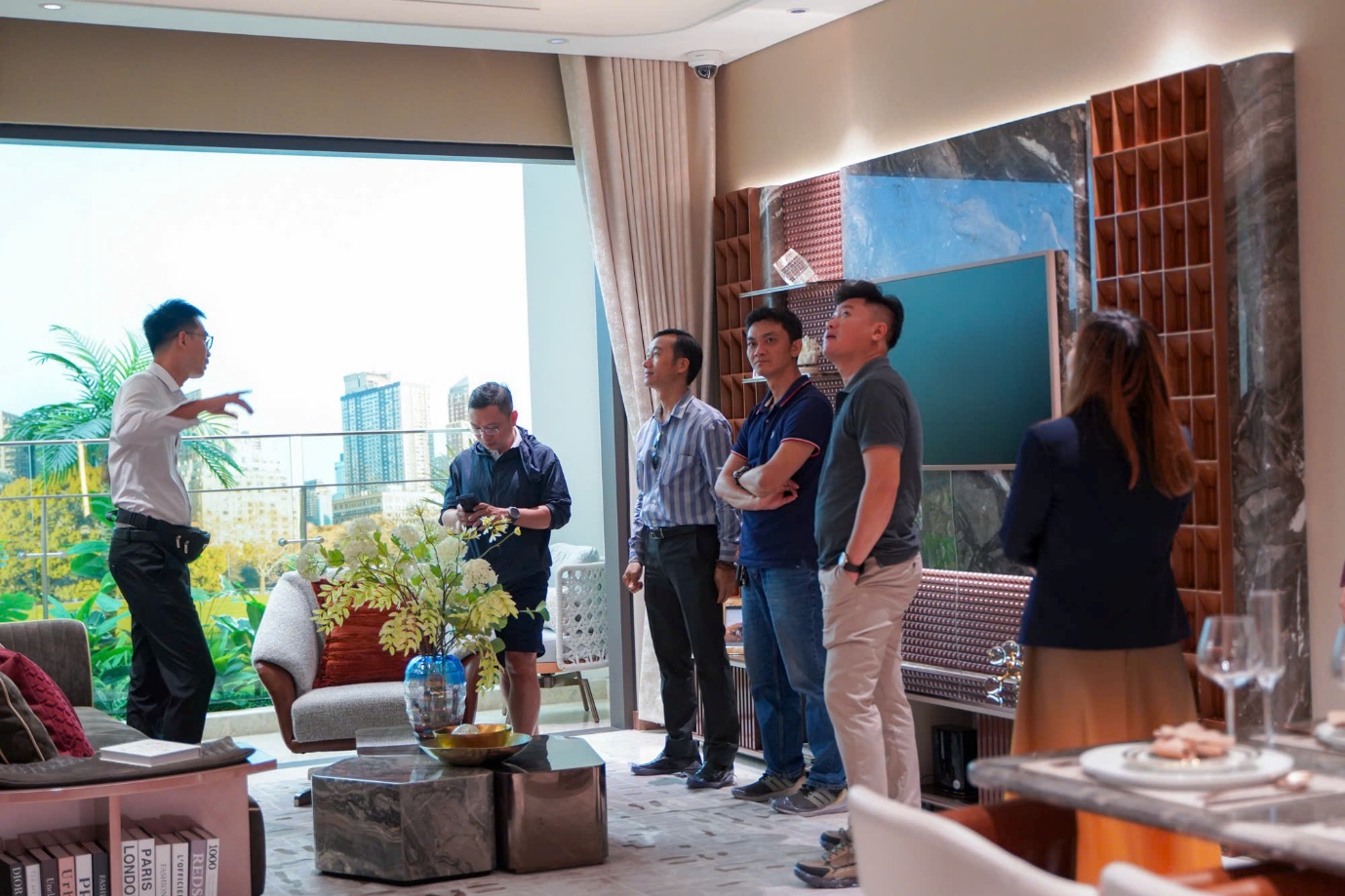 A group of people standing in a room  Description automatically generated