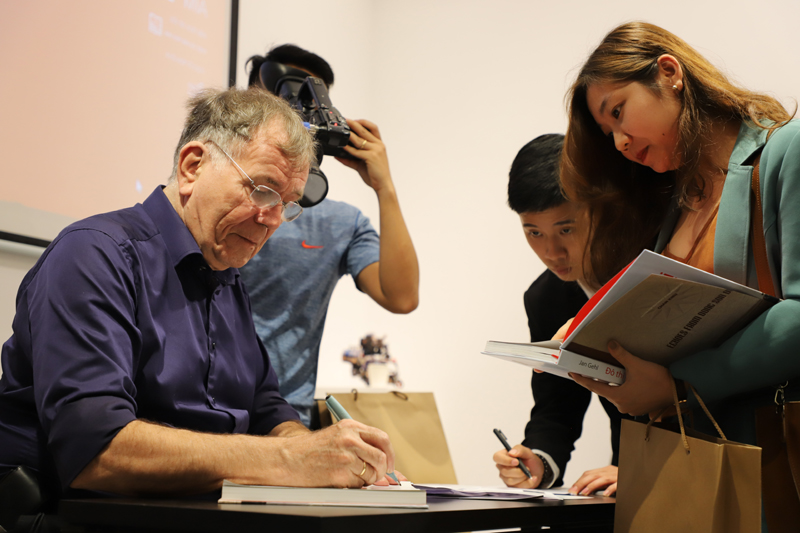 Jan Gehl signing book at the meet-and-greet. (Photo: courtesy of the Danish Embassy)