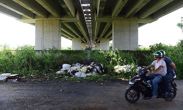 The space under a stretch of HCM City – Long Thanh – Dau Giay highway in HCM City's Thu Duc district has become a dumping ground for rubbish. (Photo: tuoitre.vn)
