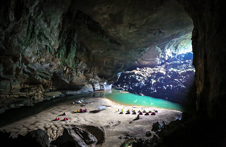 Visitors and tents in a cave of Phong Nha - Ke Bang National Park.