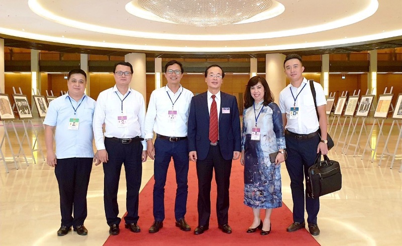 Bộ trưởng Bộ Xây dựng Phạm Hồng Hà chụp ảnh cùng Ban soạn thảo Luật Kiến trúc bên hành lang Quốc hội.