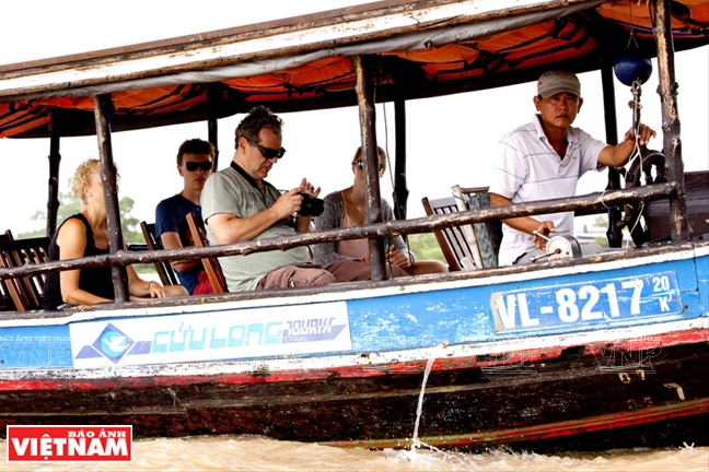 Du khách đi thuyền dọc con sông Cái Bè ngắm những khu chợ nổi.