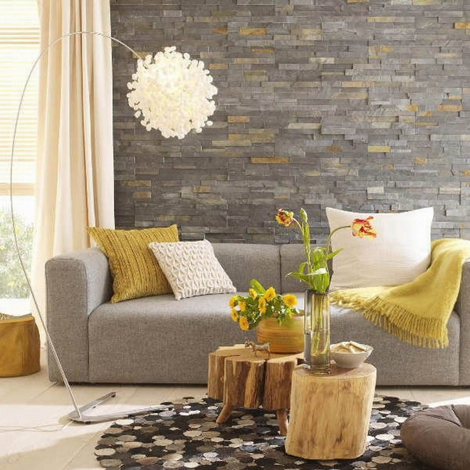 ức tường đá màu xám, ghế sofa màu xám nhẹ và những điểm nhấn màu vàng rất nhẹ tạo nên sự nhẹ nhàng, hiện đại mà tinh tế cho không gian.