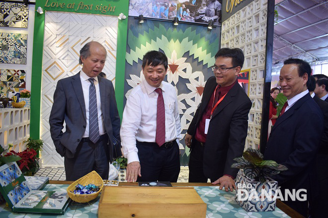 Phó Chủ tịch Thường trực UBND thành phố Đặng Việt Dũng (thứ hai từ trái) cùng Ban tổ chức đi tham quan một số gian hàng trưng bày tại triển lãm.
