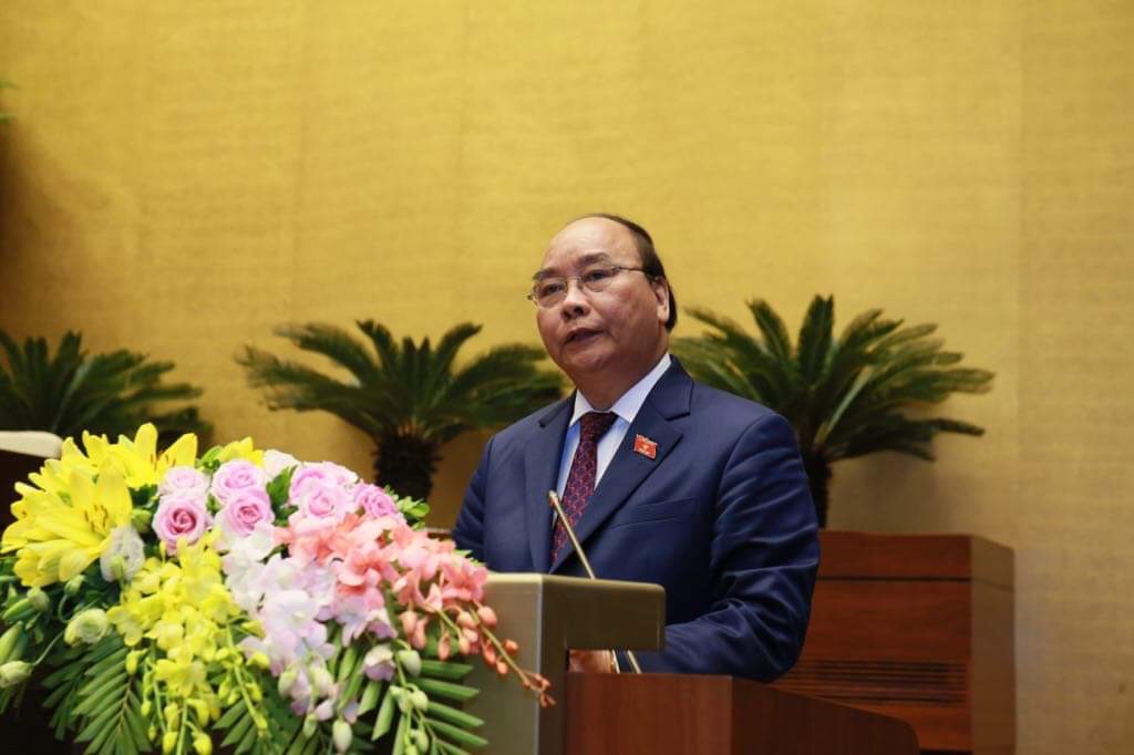 Thủ tướng Nguyễn Xuân Phúc trình bày báo cáo trước Quốc hội về tình hình KTXH 2018 - Ảnh: VGP/Nhật Bắc