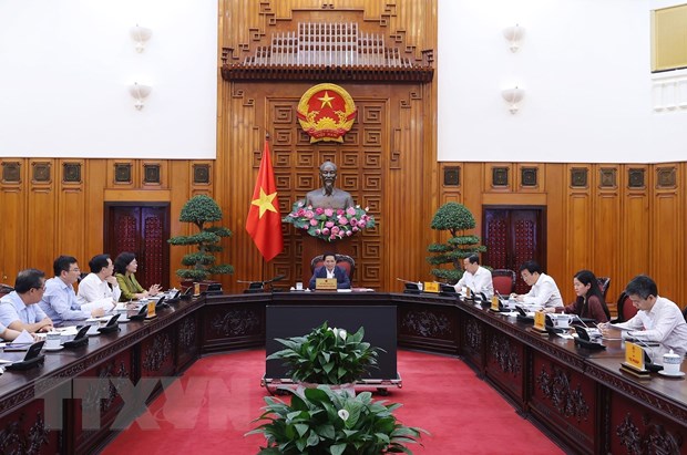 Thủ tướng Phạm Minh Chính chủ trì làm việc Ngân hàng Nhà nước, Bộ Tài chính, Bộ Tư pháp. (Ảnh: Dương Giang/TTXVN)